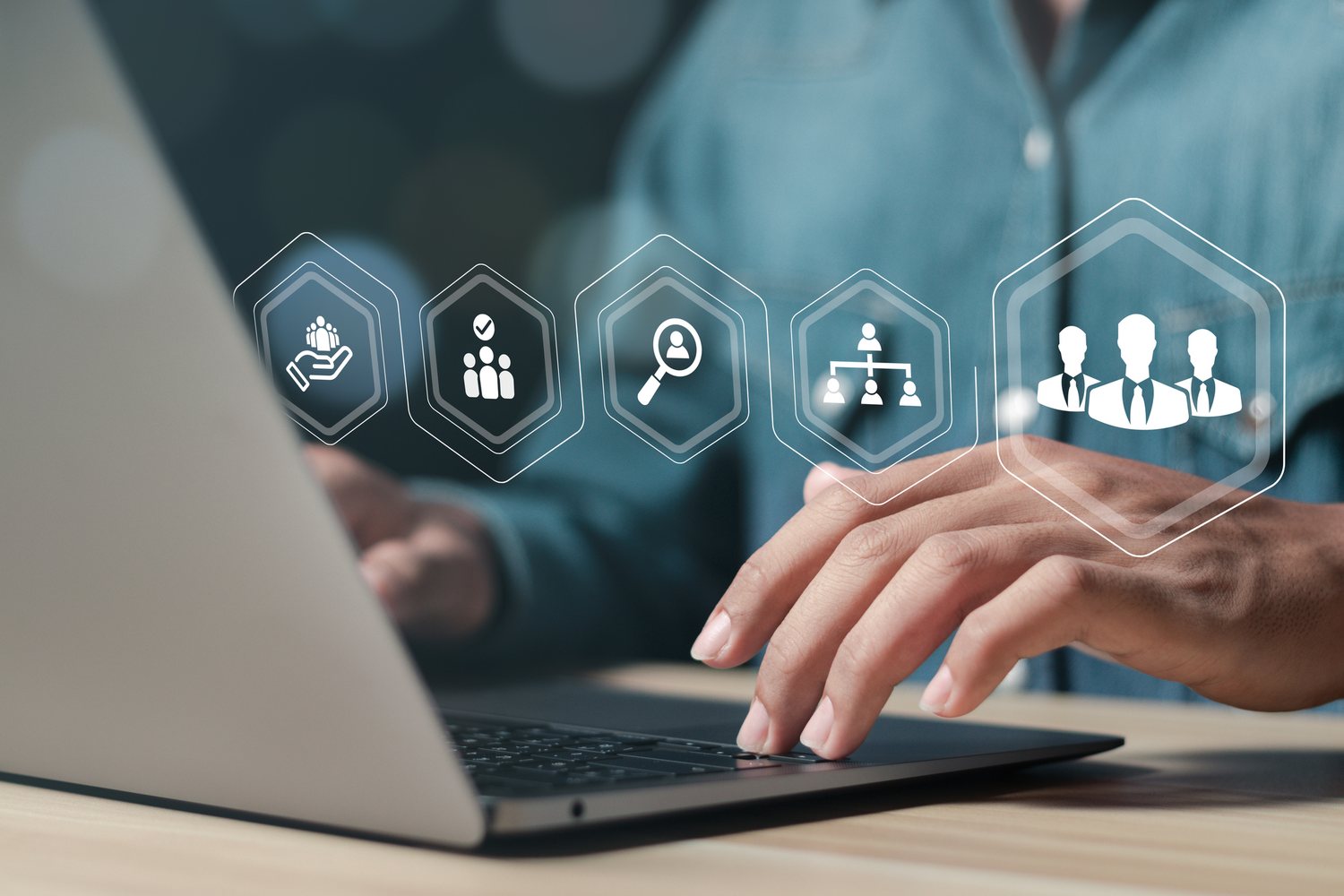 HR icons over a laptop keyboard