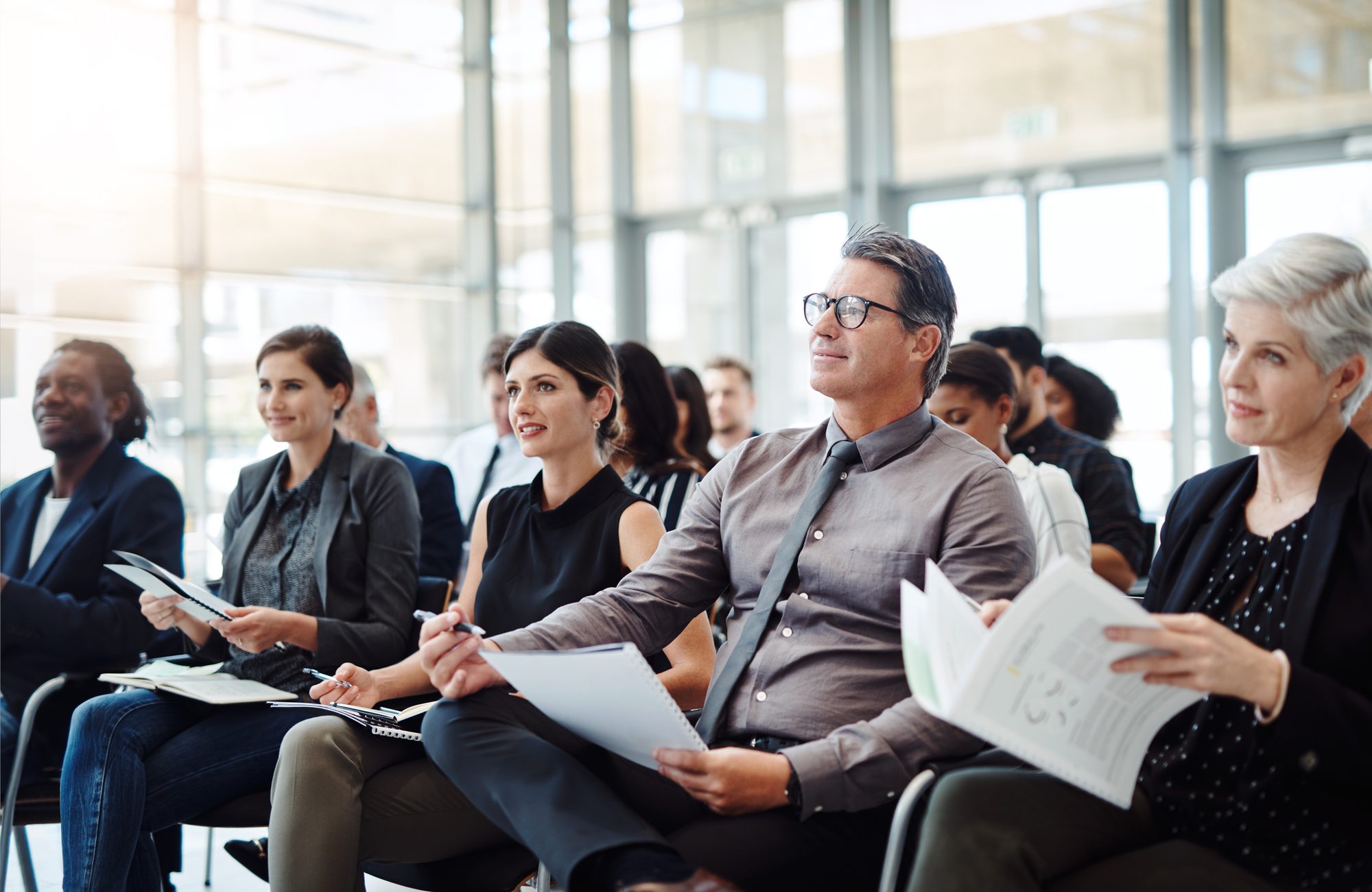 Professionals taking notes during a training session